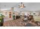 Open-concept living room with hardwood floors, neutral paint colors, a ceiling fan, and access to the kitchen at 171 Talon Dr., Conway, SC 29527