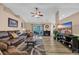 Cozy living room with a fireplace, a ceiling fan, hardwood floors, and a sliding glass door to the backyard at 171 Talon Dr., Conway, SC 29527