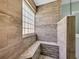 Walk-in shower features a built-in bench, glass block window, and decorative wood-look tile surround at 171 Talon Dr., Conway, SC 29527