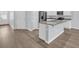 Modern kitchen with a granite-topped island, stainless steel appliances, and hardwood floors at 174 Sea Shell Dr. # 19, Murrells Inlet, SC 29576