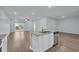 Open-concept kitchen with granite island flowing into a spacious living area and outdoor access at 174 Sea Shell Dr. # 19, Murrells Inlet, SC 29576