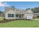 Charming single Gathering home with a manicured lawn, neutral siding, blue shutters, and an attached garage at 198 Ford Rd., Pawleys Island, SC 29585