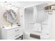 All-white bathroom with tub and stylish vanity at 201 74Th Ave. N # 1802, Myrtle Beach, SC 29572
