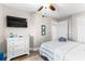 Bright bedroom featuring a queen-size bed with striped bedding and a white dresser with a TV at 201 74Th Ave. N # 1802, Myrtle Beach, SC 29572