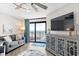 Bright living room with ocean view from the balcony, furnished with stylish seating and a modern entertainment center at 201 74Th Ave. N # 1802, Myrtle Beach, SC 29572
