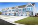 Charming townhomes featuring colorful doors, stone accents, attached garages, and well-maintained landscaping at 2078 Nw Parow Ln Nw # B, Calabash, NC 28467