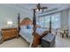A view of the primary bedroom featuring a four-poster bed, ceiling fan, and tray ceiling at 2180 Waterview Dr. # 513, North Myrtle Beach, SC 29582
