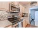 Well-equipped kitchen featuring stainless steel appliances, wooden cabinetry, and a tile backsplash, offering both functionality and style at 2180 Waterview Dr. # 513, North Myrtle Beach, SC 29582