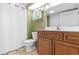 Bathroom with a wood vanity, mirror, toilet, and shower with curtain at 2301 S Ocean Blvd. # 1023, Myrtle Beach, SC 29577
