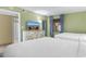 Bright bedroom featuring two beds, a dresser, and beach view television at 2301 S Ocean Blvd. # 1023, Myrtle Beach, SC 29577