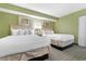 Bedroom with two beds and tropical wall decor at 2301 S Ocean Blvd. # 1023, Myrtle Beach, SC 29577