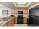 Galley kitchen featuring stainless steel appliances, granite countertops and wood cabinets at 2301 S Ocean Blvd. # 1023, Myrtle Beach, SC 29577