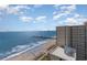 Aerial view of oceanfront condo featuring sandy beach and ocean views on a partially cloudy day at 2600 N Ocean Blvd. # 1914, Myrtle Beach, SC 29577