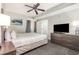 This bedroom features a ceiling fan, balcony access, and a dresser with a television at 2600 N Ocean Blvd. # 1914, Myrtle Beach, SC 29577