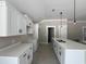 Modern kitchen with sleek white cabinetry, stylish hardware, and a spacious island with a sink at 2921 Hughes Gasque Rd., Aynor, SC 29511