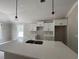 Well-designed kitchen featuring ample counter space, white cabinets, and contemporary pendant lighting at 2921 Hughes Gasque Rd., Aynor, SC 29511