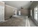 Bright living room with a ceiling fan and multiple windows, offering a versatile space for various activities at 2921 Hughes Gasque Rd., Aynor, SC 29511