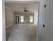 Spacious living room with ample natural light and a ceiling fan, perfect for relaxing and entertaining at 2921 Hughes Gasque Rd., Aynor, SC 29511