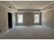 Main bedroom featuring tray ceilings, dual windows, and ample natural light for a relaxing retreat at 2925 Hughes Gasque Rd., Aynor, SC 29511
