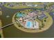 Aerial view of the clubhouse and recreation center with a pool, tennis courts, playground, and manicured grounds at 296 West Palms Dr., Myrtle Beach, SC 29579