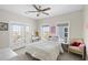 Bright bedroom features a ceiling fan, natural light, and a cute vanity area at 296 West Palms Dr., Myrtle Beach, SC 29579