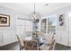 Bright dining room features modern decor, a glass table, and beautiful backyard views at 296 West Palms Dr., Myrtle Beach, SC 29579