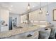 Modern kitchen with pendant lights, marble countertops, stainless appliances, and sleek white cabinetry at 296 West Palms Dr., Myrtle Beach, SC 29579