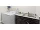 Functional laundry room with granite countertop, stainless steel sink, black cabinets, and modern washer and dryer at 296 West Palms Dr., Myrtle Beach, SC 29579