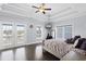 Serene main bedroom with tray ceilings, wood floors, private balcony access, and views of the surrounding landscape at 296 West Palms Dr., Myrtle Beach, SC 29579