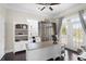 Well-lit home office featuring custom built-ins, a spacious desk, French doors to a patio, and neutral decor at 296 West Palms Dr., Myrtle Beach, SC 29579