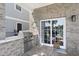 Outdoor brick patio with a stainless steel grill and covered dining area at 296 West Palms Dr., Myrtle Beach, SC 29579