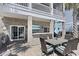 Covered outdoor kitchen and entertainment area with seating and a mounted tv at 296 West Palms Dr., Myrtle Beach, SC 29579