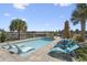 Backyard pool area with lounge chairs, palm trees, and a distant golf course view at 296 West Palms Dr., Myrtle Beach, SC 29579