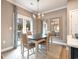 Charming dining area features a modern chandelier and French doors leading to the outdoors at 300 Golan Circle # A, Myrtle Beach, SC 29579