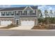 Charming townhome with a two-car garage, stone accents, and manicured landscaping at 300 Golan Circle # A, Myrtle Beach, SC 29579