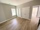 Bright bedroom with ample closet space, complemented by wood-look floors and neutral wall tones at 311 St. Andrews Ln., Myrtle Beach, SC 29588