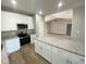 Bright kitchen with an island, granite counters, stainless steel appliances, and wooden floors at 311 St. Andrews Ln., Myrtle Beach, SC 29588