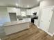 Modern kitchen featuring an island, stainless steel appliances, granite countertops, and white cabinets at 311 St. Andrews Ln., Myrtle Beach, SC 29588