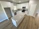 Modern kitchen featuring an island, stainless steel appliances, granite countertops, and white cabinets at 311 St. Andrews Ln., Myrtle Beach, SC 29588