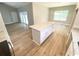 An open kitchen with an island, granite counters, hardwood floors, and white cabinets at 311 St. Andrews Ln., Myrtle Beach, SC 29588