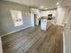 Bright open floor plan kitchen featuring white cabinets, hardwood floors, stainless steel appliances, and island at 311 St. Andrews Ln., Myrtle Beach, SC 29588