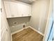 Convenient laundry room featuring ample white cabinet storage space and modern hookups at 311 St. Andrews Ln., Myrtle Beach, SC 29588