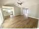 Spacious living room next to a kitchen featuring wood floors, high ceilings, and a ceiling fan at 311 St. Andrews Ln., Myrtle Beach, SC 29588