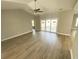 Spacious living room next to a sunroom featuring wood floors, high ceilings, and a ceiling fan at 311 St. Andrews Ln., Myrtle Beach, SC 29588