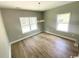 Well-lit living room with hardwood floors and bright windows at 311 St. Andrews Ln., Myrtle Beach, SC 29588
