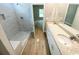 A primary bathroom with a walk-in shower and double granite vanity at 311 St. Andrews Ln., Myrtle Beach, SC 29588