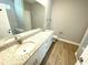A primary bathroom featuring a granite vanity, double sinks, and a walk-in shower at 311 St. Andrews Ln., Myrtle Beach, SC 29588