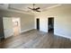 A spacious main bedroom suite with hardwood floors, tray ceiling, and a fan at 311 St. Andrews Ln., Myrtle Beach, SC 29588