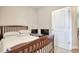 Bedroom with dark wood bed frame next to a white door at 321 Galway Ct., Longs, SC 29568