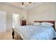 Bedroom featuring a wood framed bed with blue patterned bedding, a ceiling fan, and neutral walls at 321 Galway Ct., Longs, SC 29568